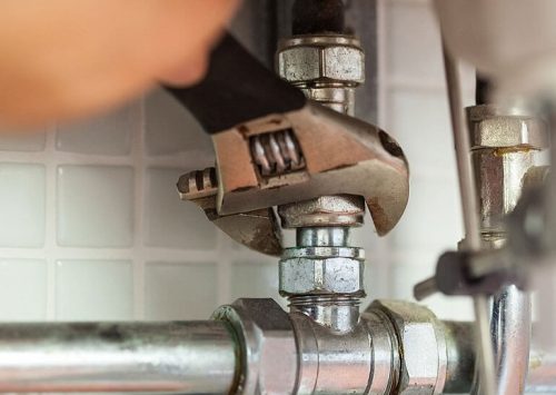 fixing pipes close up - Wellington Plumbers
